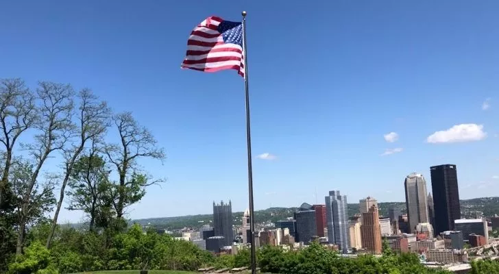 The USA flag with Pittsburg in the background