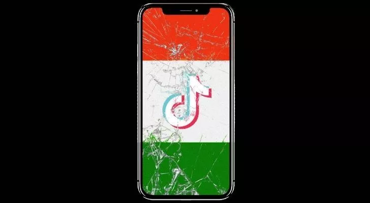 A smashed smart phone with India's flag on the screen and the Tik Tok logo in the middle