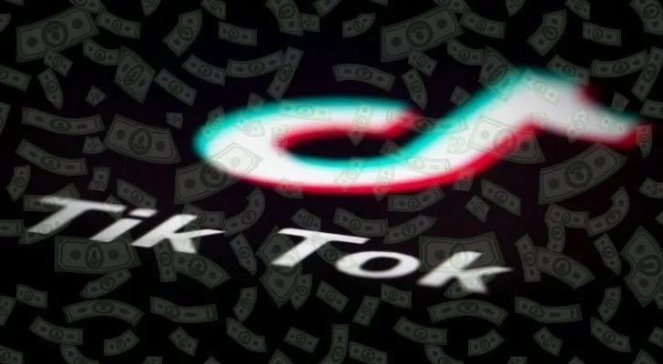 Tik Tok logo with lots of dollars floating over it