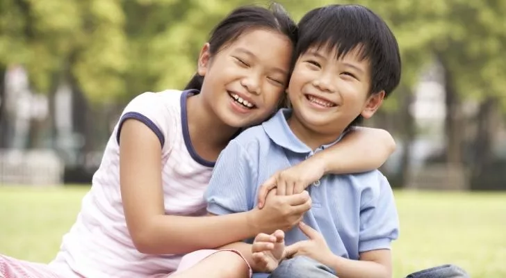 A Chinese brother and sister smiling