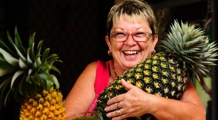 A picture of Christine McCallum holding the world's biggest grown pineapple