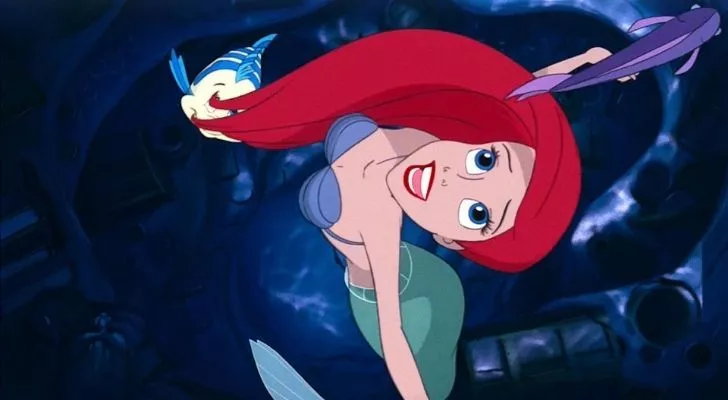 Ariel from the Little Mermaid looking up and dreaming about walking on land