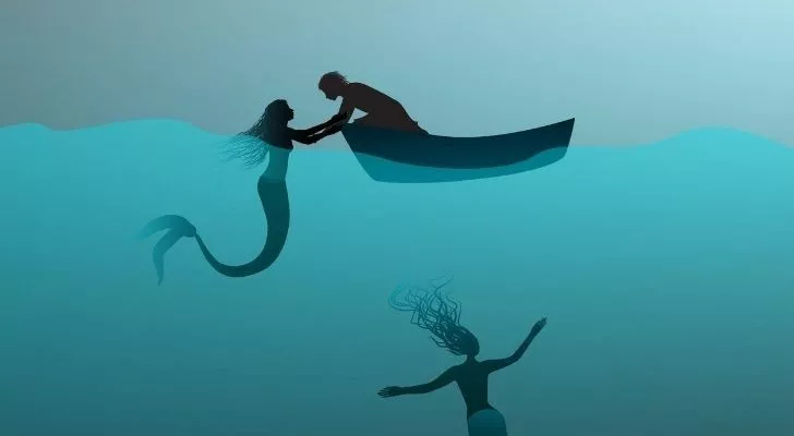 A mermaid pulling a sailor into the seas