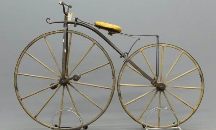 A golden boneshaker bicycle