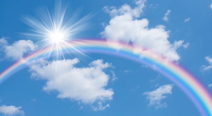 A rainbow and the sun in the sky