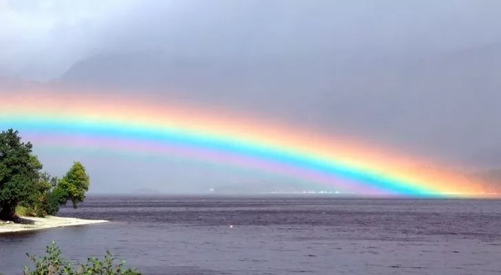 A rainbow over a lake