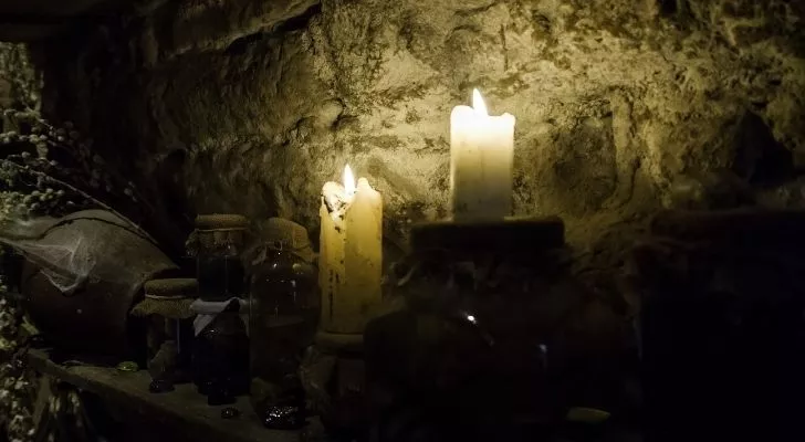 Lit candles in dark and dreary looking room