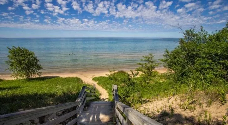 A walkway through bushes to where the Michigan Triangle rests