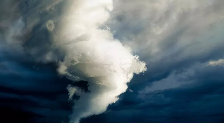 A massive tornado surrounded by heavy dark clouds