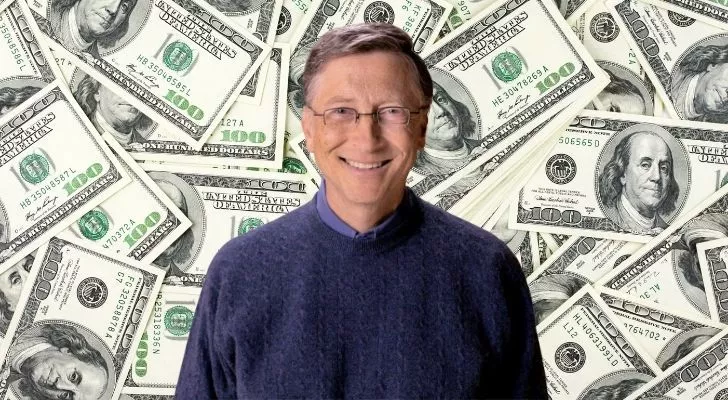 Bill Gates smiling with lots of one hundred dollar bills behind him