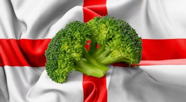 Two pieces of broccoli with the English flag behind them