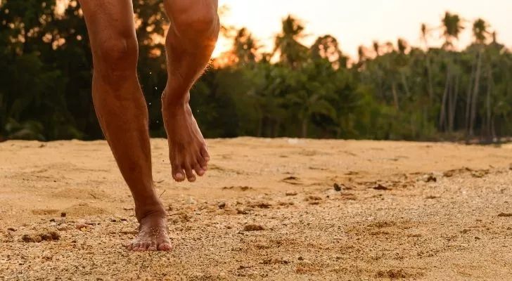Someone running on the beach barefoot