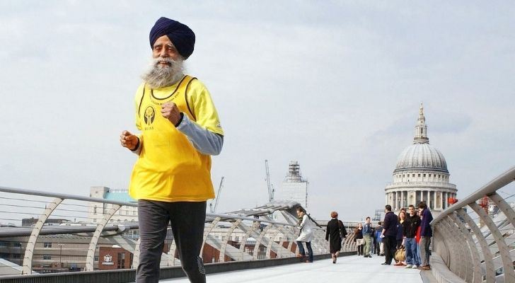 Fauja Singh running across a bridge