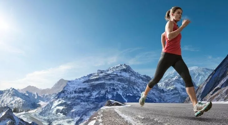 A woman running high in the mountains