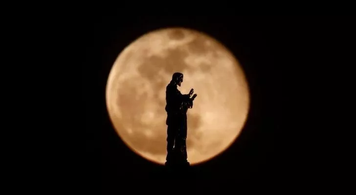 A Catholic statue with the moon behind