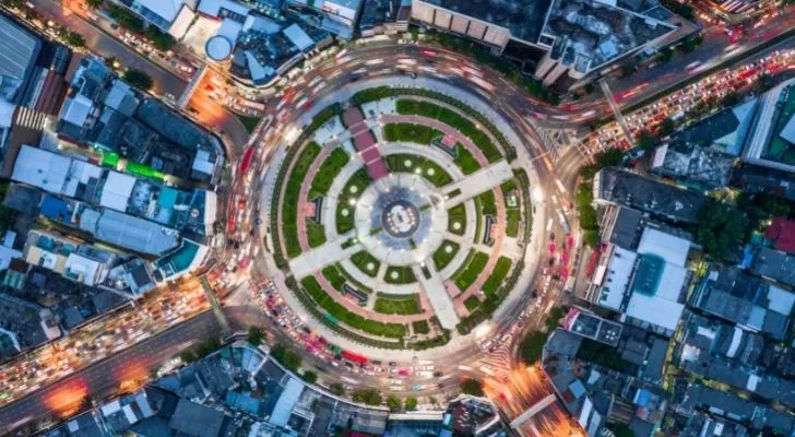 A busy city roundabout glowing in the dark