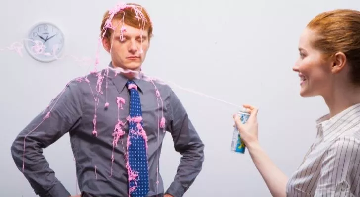 Someone being squirted with silly string