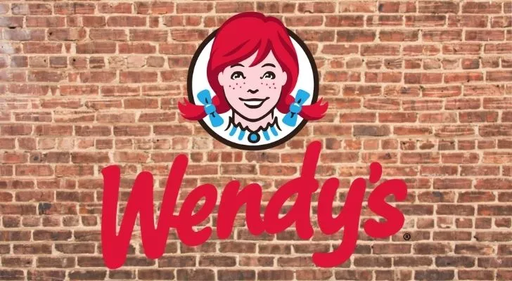 The Wendy's logo on a brick wall