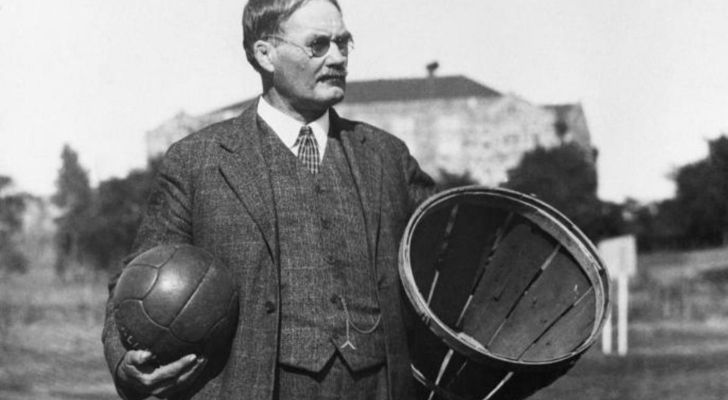 James Naismith holding a basketball and basket