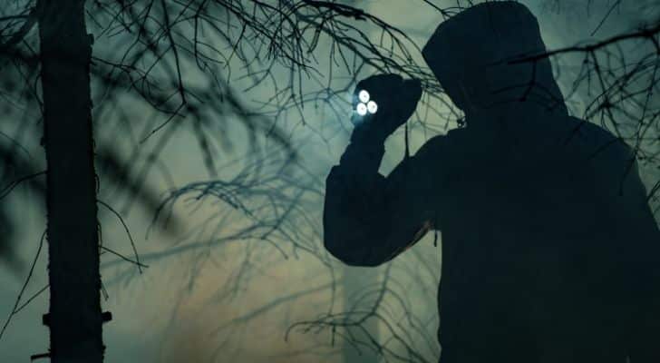 Someone looking for a missing person in the dark