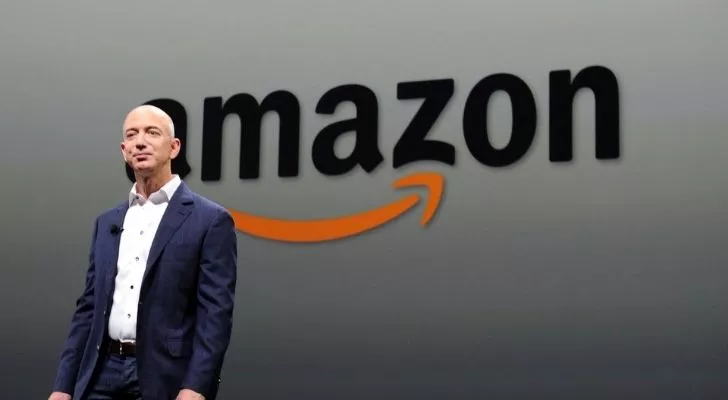 Jeff Bezos with the Amazon logo behind him