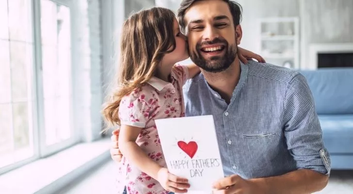 A father being kissed on the cheek on Father's Day