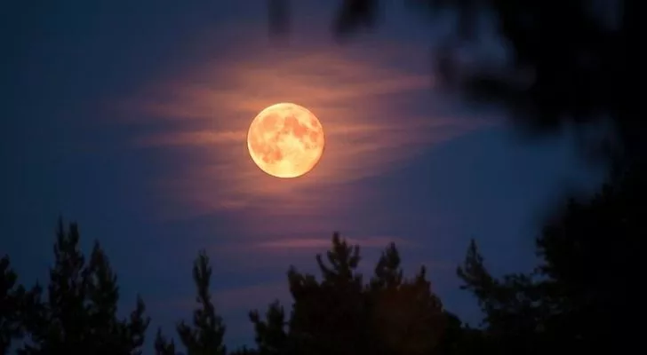 The Beaver Moon with a few clouds in front of it