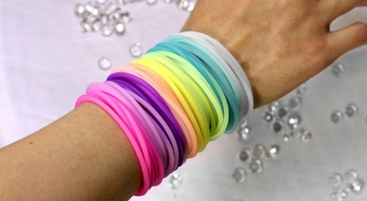 A woman wearing lots of jelly bracelets