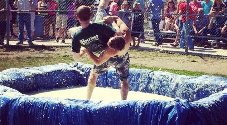 Two boys wrestling in mashed potato