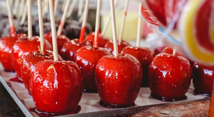 Many red candy apples on sticks