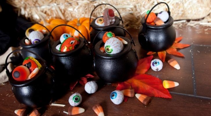 Candy cauldron buckets full of Halloween candy goodies