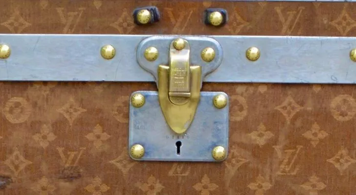 A closeup of a Louis Vuitton trunk lock