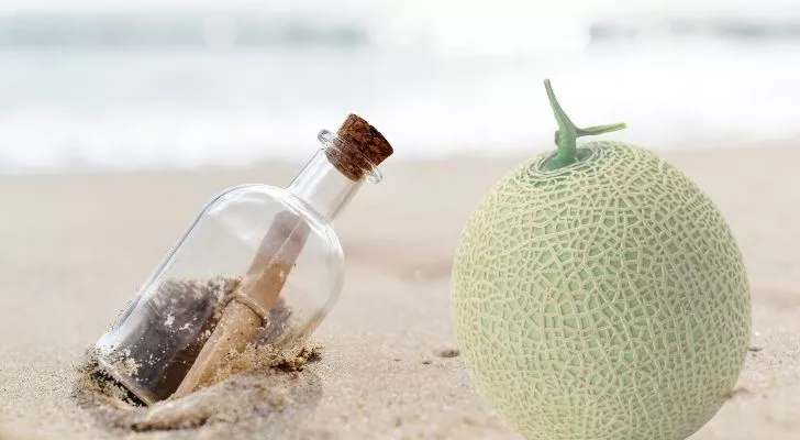 Message in a bottle with a melon next to it