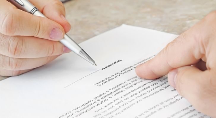 Person about to sign a document