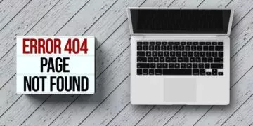 A laptop beside a error 404 sign