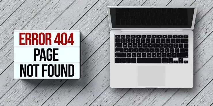 A laptop beside a error 404 sign