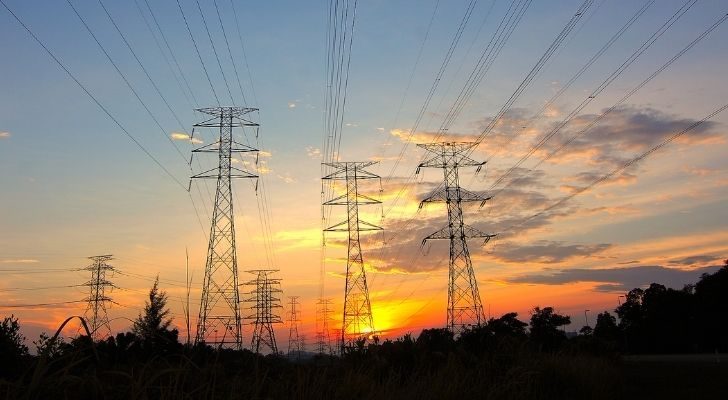 Electricity grids behind a sunset