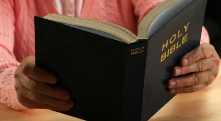 Person reading The Holy Bible