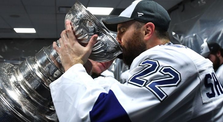 A person drinking from the Stanley Cup.