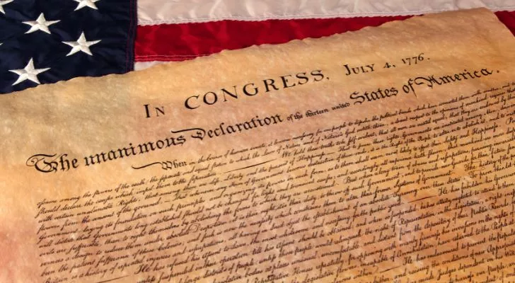The Declaration of Independence on top of the American flag.
