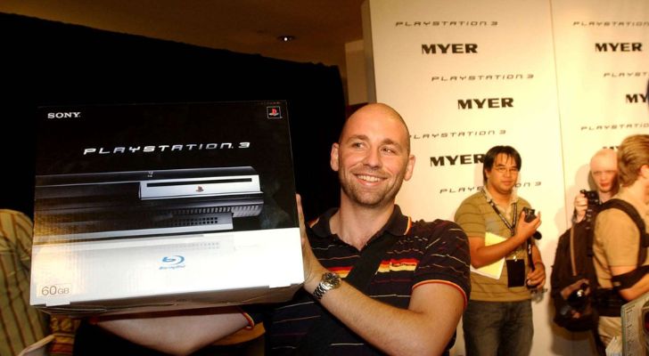 A person holding a box of the Playstation 3.