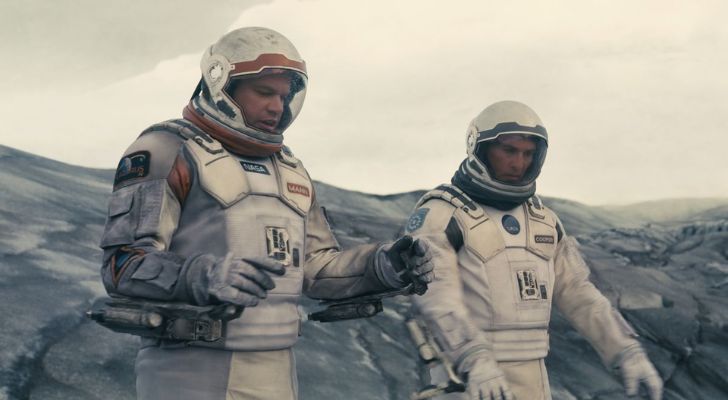 Actors Matthew McConaughey and Matt Damon wearing space suits in the movie Interstellar.