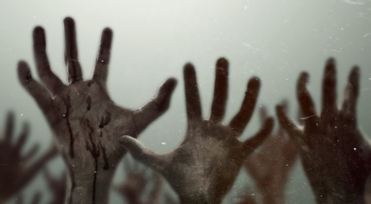 Zombie hands reaching up into the air