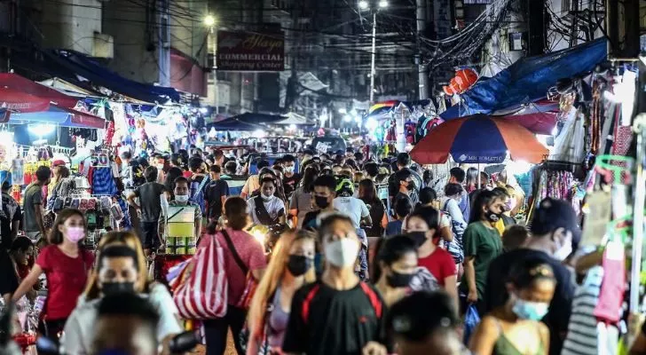 A crowded street full of Filipino people