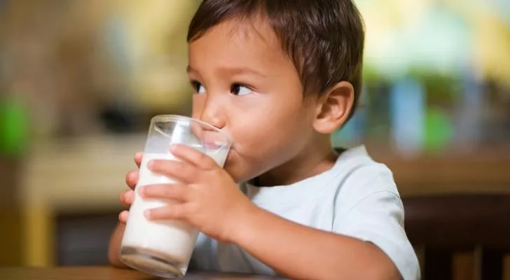 A boy drinking a glass of milk