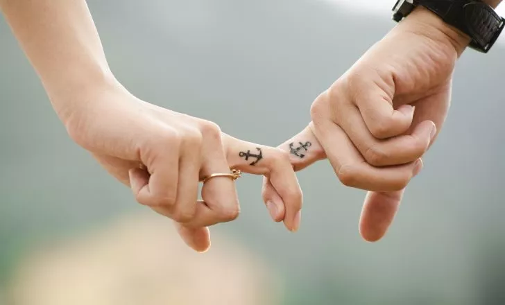 Two persons with matching tattoos.