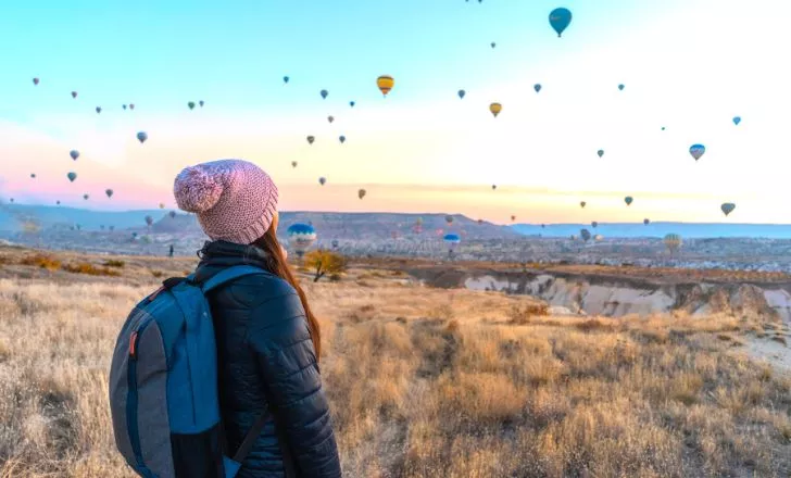 A person looking at hot air balloons in Cappadocia
