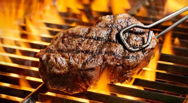 A steak grilling on a bbq