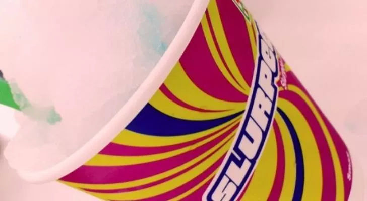 A Slurpee cup with a white-colored Slurpee in it