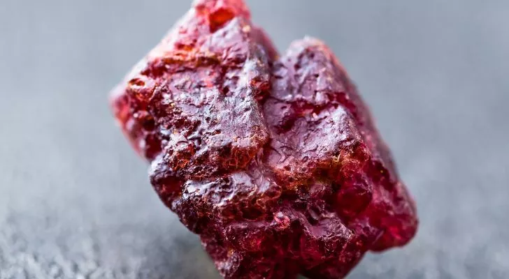 A dark red uncut spinel gemstone